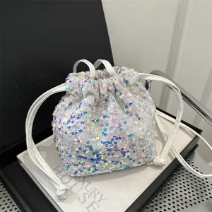 Sparkly white sequin drawstring bucket bag with iridescent blue purple shimmer