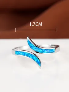 Macro shot of a minimalist silver ring with blue opal inlay and a 1.7cm inner diameter