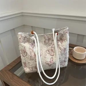 Large butterfly print tote bag in cream fabric with white tassels and rope straps
