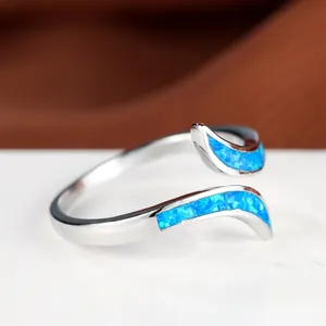 Minimalist silver wave ring with vibrant blue opal inlay and adjustable open band design
