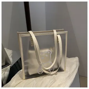 Detail of translucent jelly tote bag with cream trim and cartoon bear design