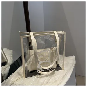Detail of transparent PVC tote with white leather handles and cartoon bear printing