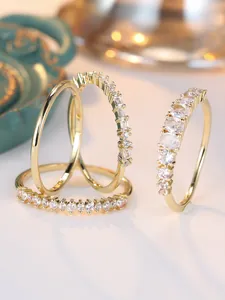 Detailed macro shot of stacked gold stackable rings with sparkling cubic zirconia stones