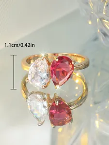 Détail de deux zircons en forme de goutte sur bague dorée avec mesure de 1,1 cm de hauteur