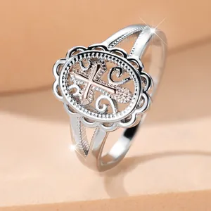 Vintage silver ring with rose gold cross centerpiece and hollow filigree design