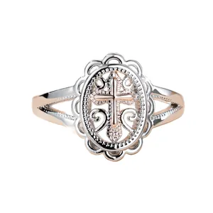 Vintage two-tone rose gold cross ring with intricate hollow lace detailing on silver band