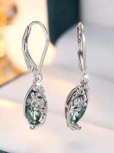 Macro shot of S925 silver leaf earrings with natural green moss agate stones