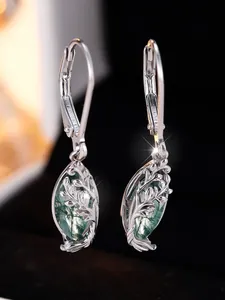 Macro detail of S925 silver earring with hollow leaf design and green moss agate stone