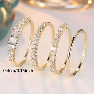 Set of four gold-finish rings with colorful cubic zirconia and minimalist bands