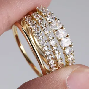 Elegant 4-piece gold ring set featuring minimalist bands and sparkling zircon stones