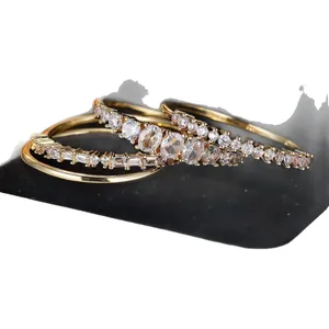 Three-piece gold-tone ring set featuring round and rectangular cubic zirconia stones
