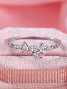 Macro detail of S925 sterling silver bow ring with sparkling pear-shaped zircons