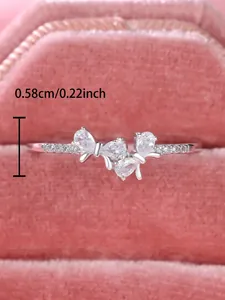 Macro detail of S925 silver bow ring with sparkling pear-shaped zircons and dimensions