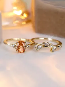 Detail of gold-plated ring set with oval champagne stone and marquise cubic zirconia