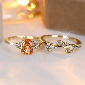 Elegant gold ring set featuring an oval amber zircon and a marquise leaf design.