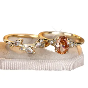 Exquisite gold ring set with oval champagne gemstone and marquise white crystals