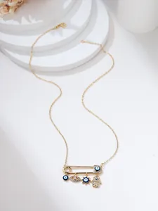 Detail of paperclip necklace featuring gold charms, evil eye, and hamsa hand pendants