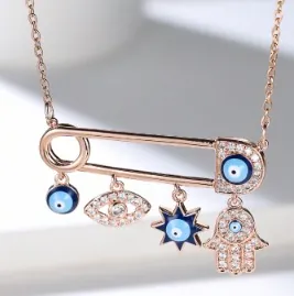 Rose gold paperclip necklace with evil eye pendants and Hamsa hand charm in rose gold