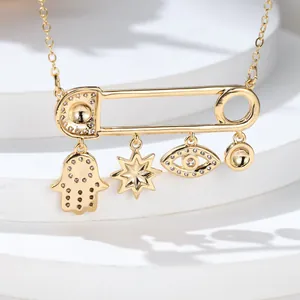 Gold paperclip necklace with evil eye, hamsa hand and star charms with zircons