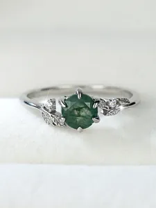 Macro detail of moss agate ring with leaf design and sparkling side stones