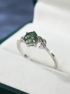 Macro shot of S925 silver ring featuring green moss agate and leaf detail with zircons
