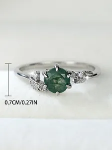 Detail shot of vintage S925 silver ring featuring round green agate and leaf design