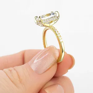 Detailed side view of luxury rectangular white diamond ring with gold finish and pavé accents
