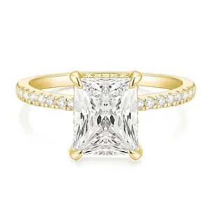 Macro shot of rectangular white diamond ring with four-prong setting and side accents