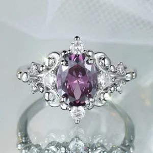 Elegant vintage oval purple gemstone ring with white zircon accents on silver band