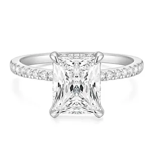 Elegant emerald-cut white diamond ring with radiant side stones in silver band setting