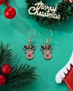 Detail view of cute reindeer earrings with red nose on a festive green background
