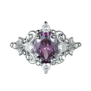 Elegant silver ring with oval purple gemstone and white zircon accents on white background