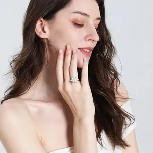 Close-up of rectangular white zircon ring with four-claw setting on model hand