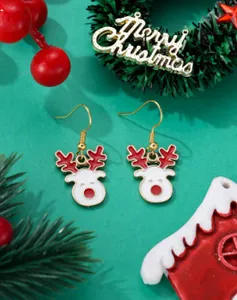 Close-up of cute Christmas reindeer earrings with red and gold festive details