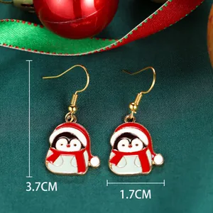 Detail of Christmas penguin drop earrings with red hat and dimensions 3.7cm by 1.7cm