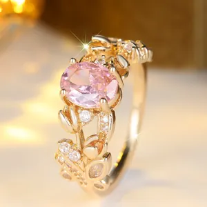 French vintage floral ring with pink oval gemstone and white diamond accents in 18K gold