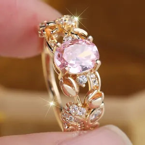 Vintage gold ring with oval pink stone and white diamonds in floral filigree design