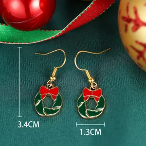 Detailed view of Christmas wreath earrings with dimensions 3.4cm by 1.3cm in holiday setting