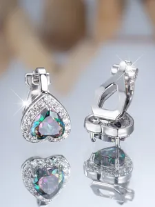 Détail macro de boucles d'oreilles clips en cœur avec pierres colorées et pavé diamants
