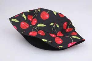 Detail shot of the fine stitching and cherry fruit pattern on the black sun hat fabric