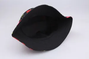 Close-up of black cotton bucket hat with cherry print showing inner lining and stitching