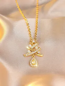 Detail of Christmas tree pendant with sparkling yellow teardrop gem on champagne satin