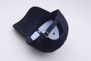 Detail der marineblauen Baumwoll-Basecap mit verstellbarer silberner Metallschnalle hinten