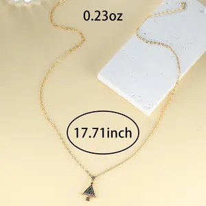 Detailed view of gold Christmas tree necklace with specs: 0.23oz weight and 17.71 inch length