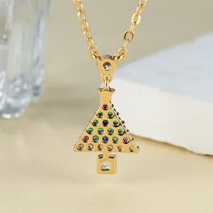 Macro detail of Christmas tree pendant with vibrant multi-color zircon stones on gold chain