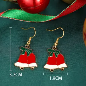 Detailed view of Christmas bell earrings with green bows and red enamel finish, 3.7cm height