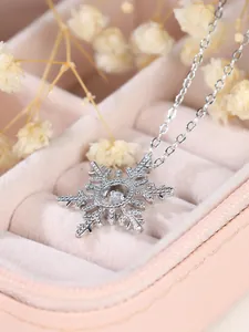 Macro view of silver snowflake pendant necklace with sparkling pavé cubic zirconia