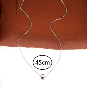 Detail of a 45cm silver chain necklace with a red Christmas hat pendant and I Love U text