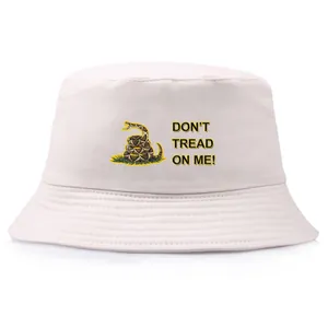 Cream cotton bucket hat featuring Gadsden Flag snake print and Don't Tread On Me text