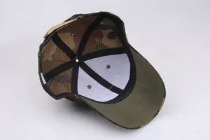 Detail view of tactical camo cap interior with reinforced stitching and metal eyelets